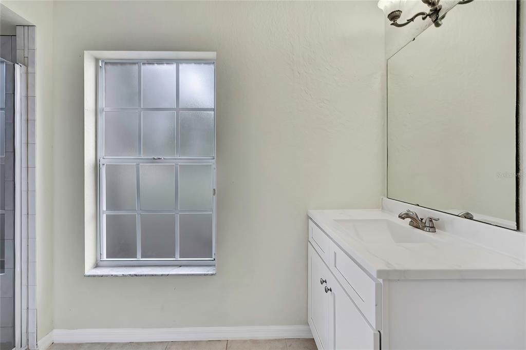 12052 Jade Avenue Spring Hill, FL 34609 - Photo 26 of 45 a bathroom with a sink and a mirror