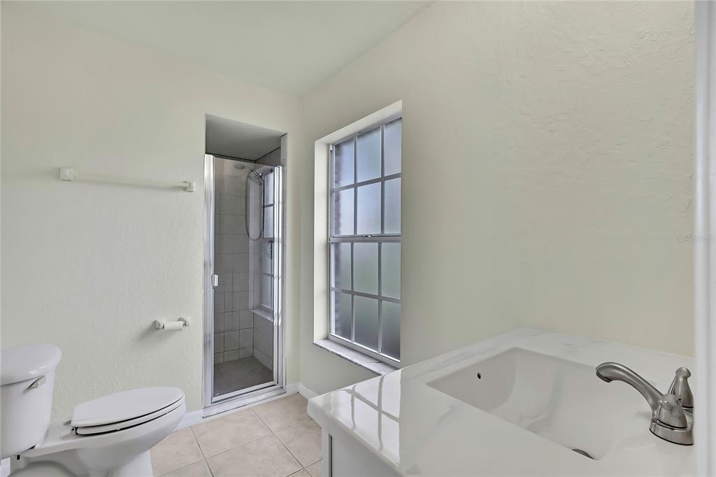 12052 Jade Avenue Spring Hill, FL 34609 - Photo 27 of 45 a bathroom with a bathtub and toilet
