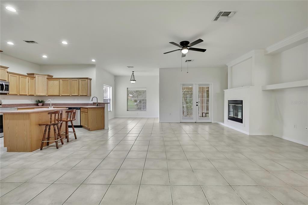 12052 Jade Avenue Spring Hill, FL 34609 - Photo 3 of 45 a view of kitchen with stainless steel appliances granite countertop a stove top oven a sink a counter top space and cabinets