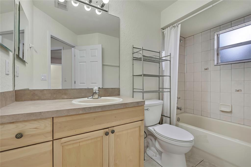 12052 Jade Avenue Spring Hill, FL 34609 - Photo 31 of 45 a bathroom with a sink toilet vanity and shower