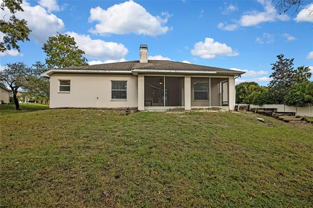 a view of a backyard with a garden and trees
