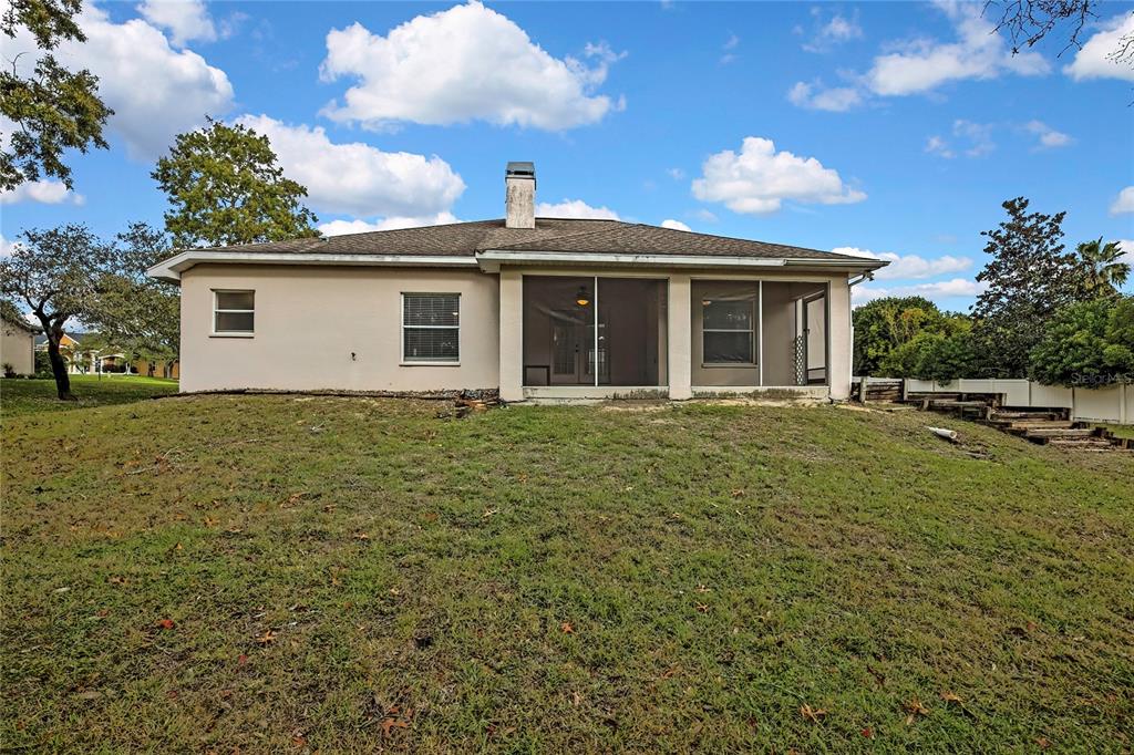 12052 Jade Avenue Spring Hill, FL 34609 - Photo 34 of 45 a front view of a house with a garden