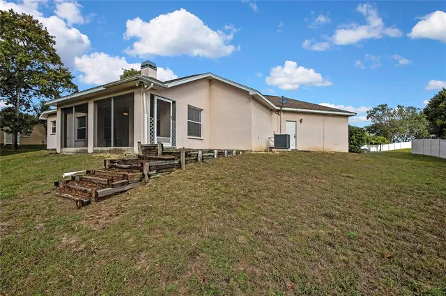 a view of a livingroom with a ceiling fan and window