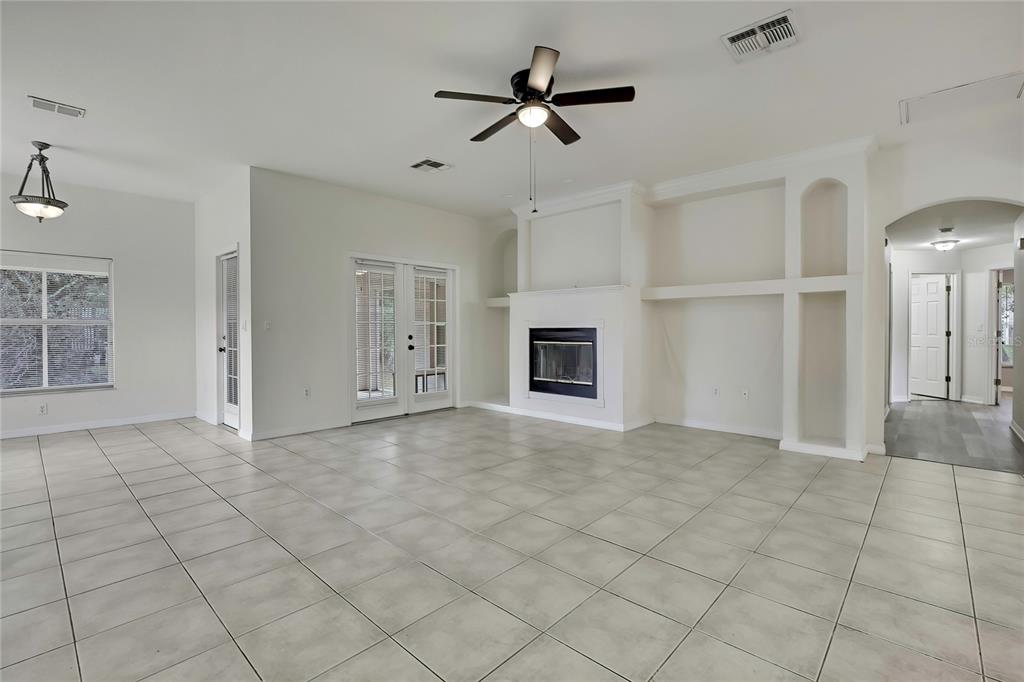 12052 Jade Avenue Spring Hill, FL 34609 - Photo 4 of 45 a view of an empty room with a fireplace