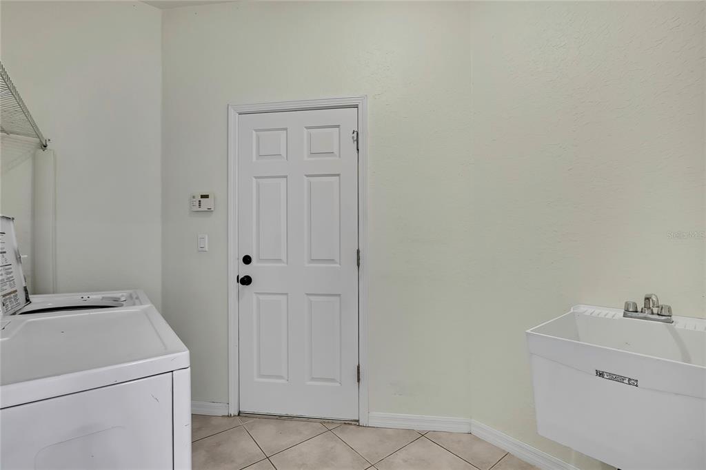 12052 Jade Avenue Spring Hill, FL 34609 - Photo 43 of 45 a view of a bathroom with utility and sink