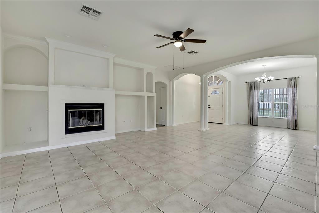 12052 Jade Avenue Spring Hill, FL 34609 - Photo 5 of 45 a view of an empty room with a fireplace