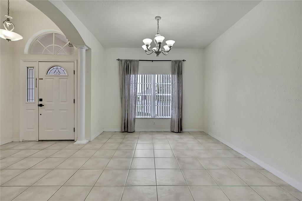 12052 Jade Avenue Spring Hill, FL 34609 - Photo 8 of 45 a view of an empty room with a window