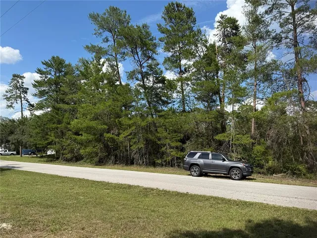 a house view with a play ground in front of it