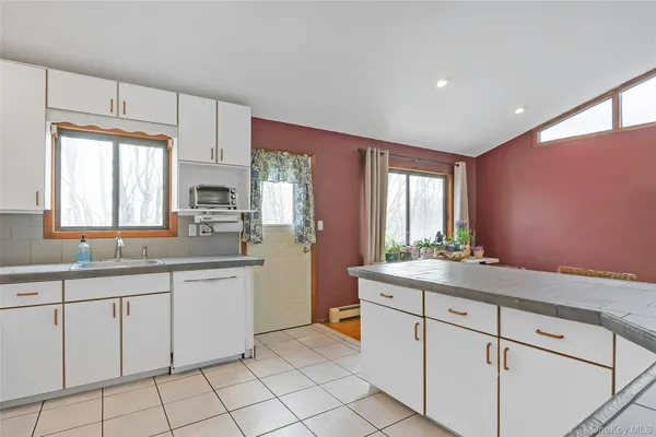 a kitchen with stainless steel appliances granite countertop a refrigerator stove and sink