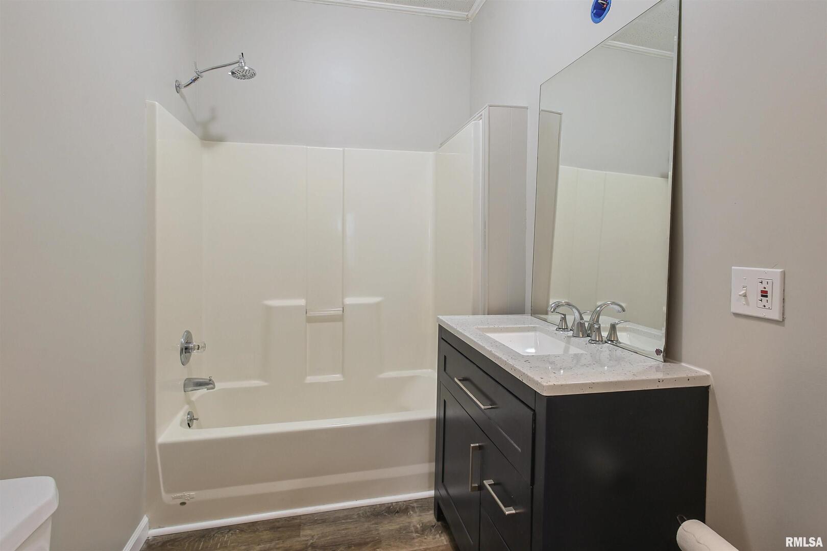 208 South 10th Street Herrin, IL 62948 - Photo 16 of 24 a bathroom with a sink a toilet and shower