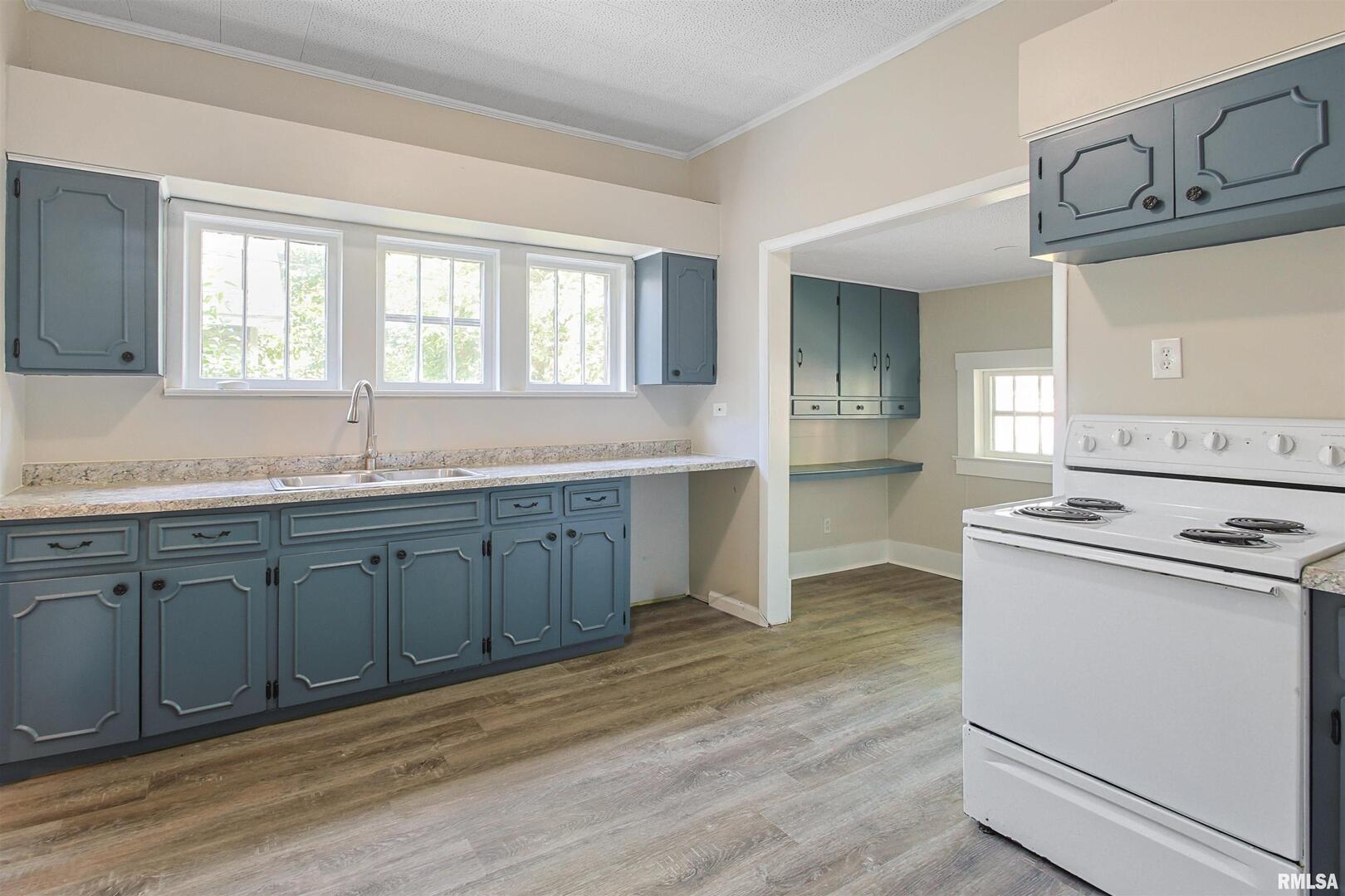 208 South 10th Street Herrin, IL 62948 - Photo 7 of 24 a kitchen with granite countertop cabinets stainless steel appliances and a sink