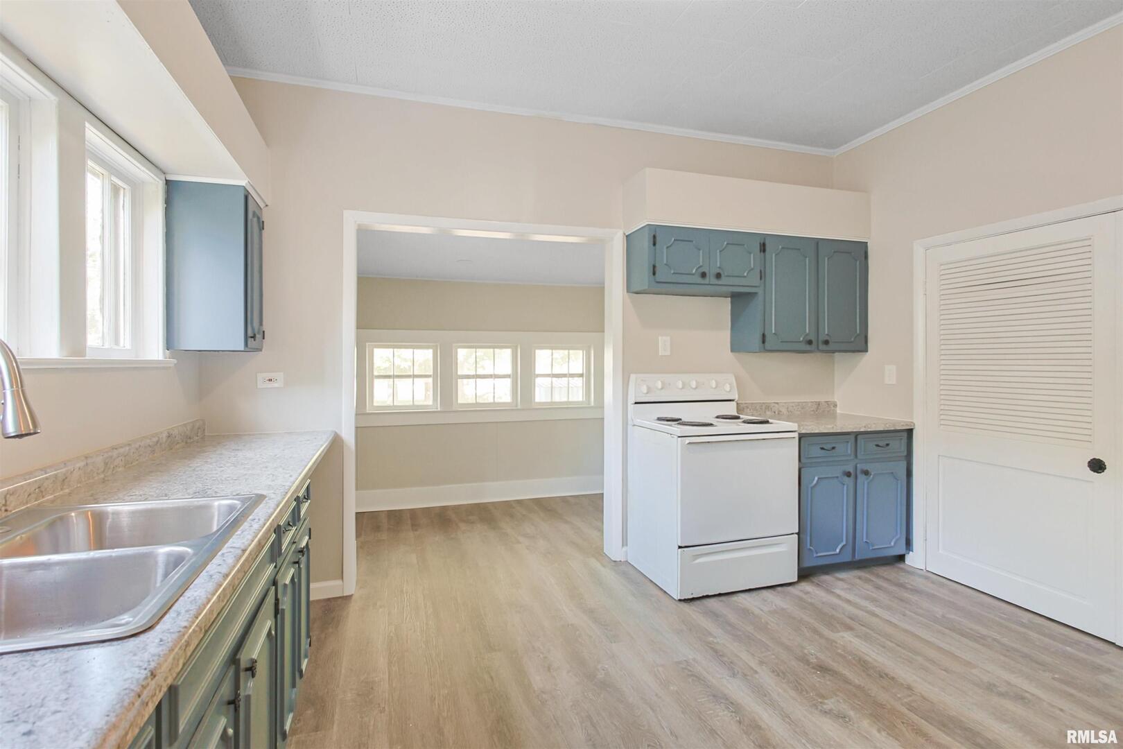 208 South 10th Street Herrin, IL 62948 - Photo 8 of 24 a kitchen with a sink stove top oven and cabinets