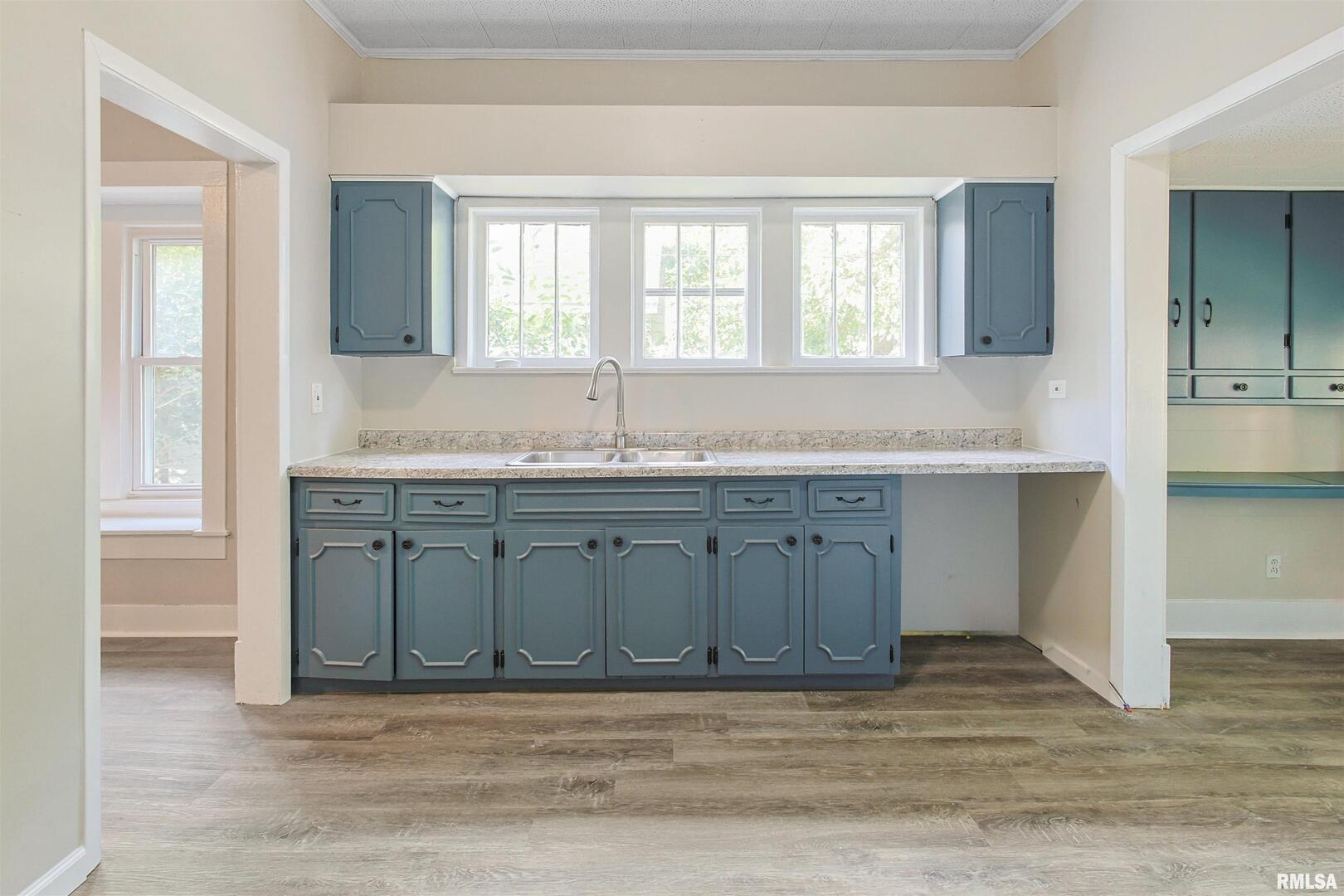 208 South 10th Street Herrin, IL 62948 - Photo 9 of 24 a view of a kitchen with a sink cabinet and a mirror