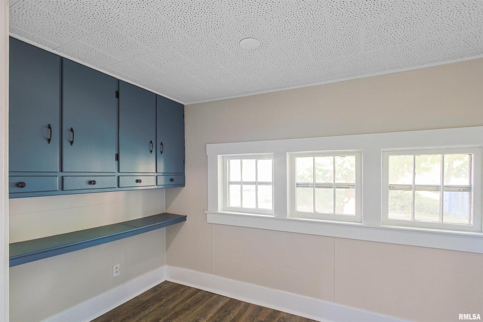 208 South 10th Street Herrin, IL 62948 - Photo 10 of 24 a kitchen with stainless steel appliances cabinets and wooden floor