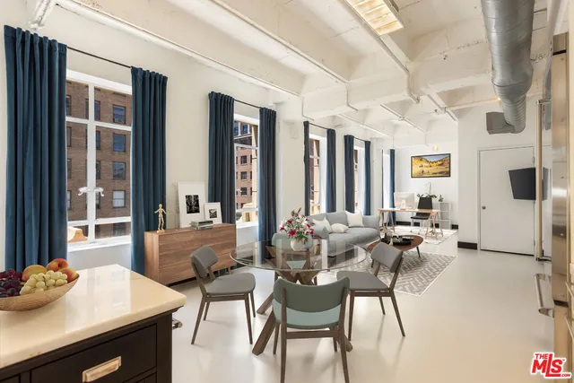 a living room with furniture and large windows