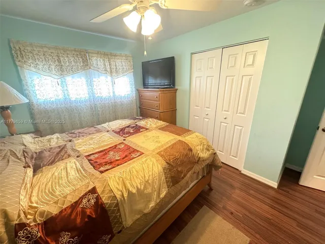a bed sitting in a spacious bedroom next to a window