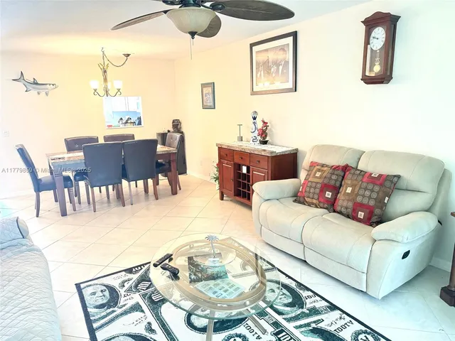 a living room with furniture wooden floor and dining table