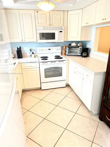 a kitchen with stainless steel appliances a stove a sink a microwave and a refrigerator