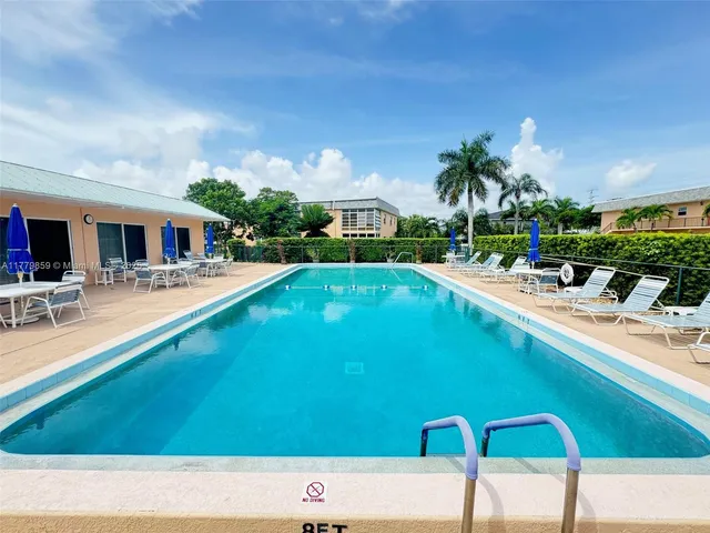 a swimming pool with outdoor seating and yard