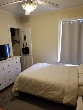 a bedroom with a bed and window