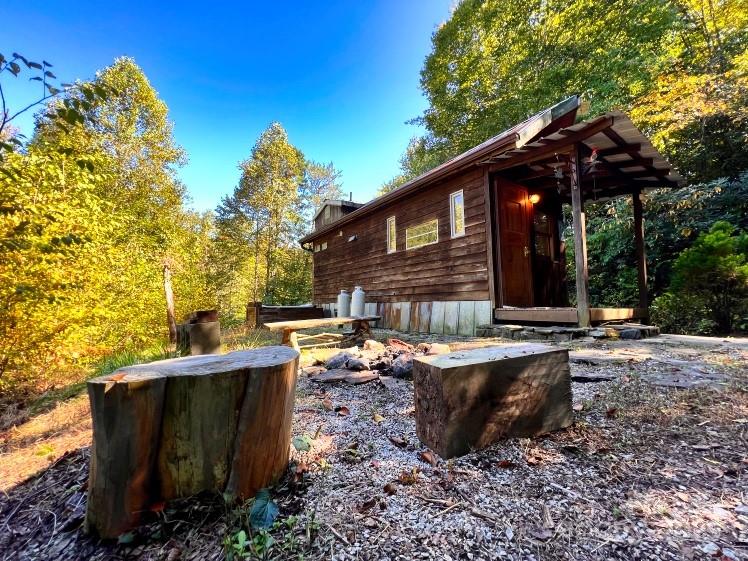 3929 Parker Padgett Road Old Fort, NC 28762 - Photo 12 of 23 a view of a house with backyard and sitting area