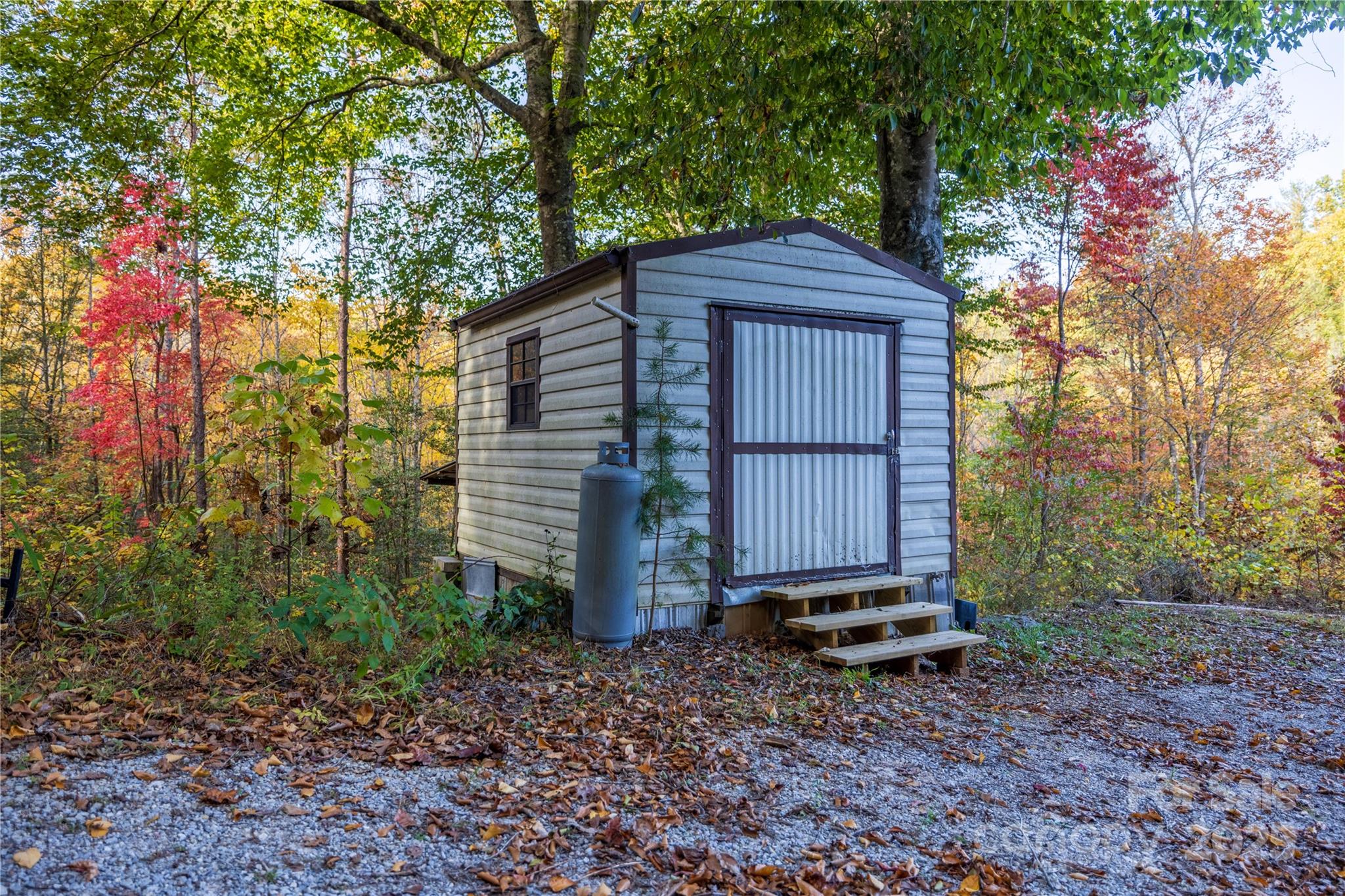 3929 Parker Padgett Road Old Fort, NC 28762 - Photo 14 of 23 a small barn in the middle of a yard