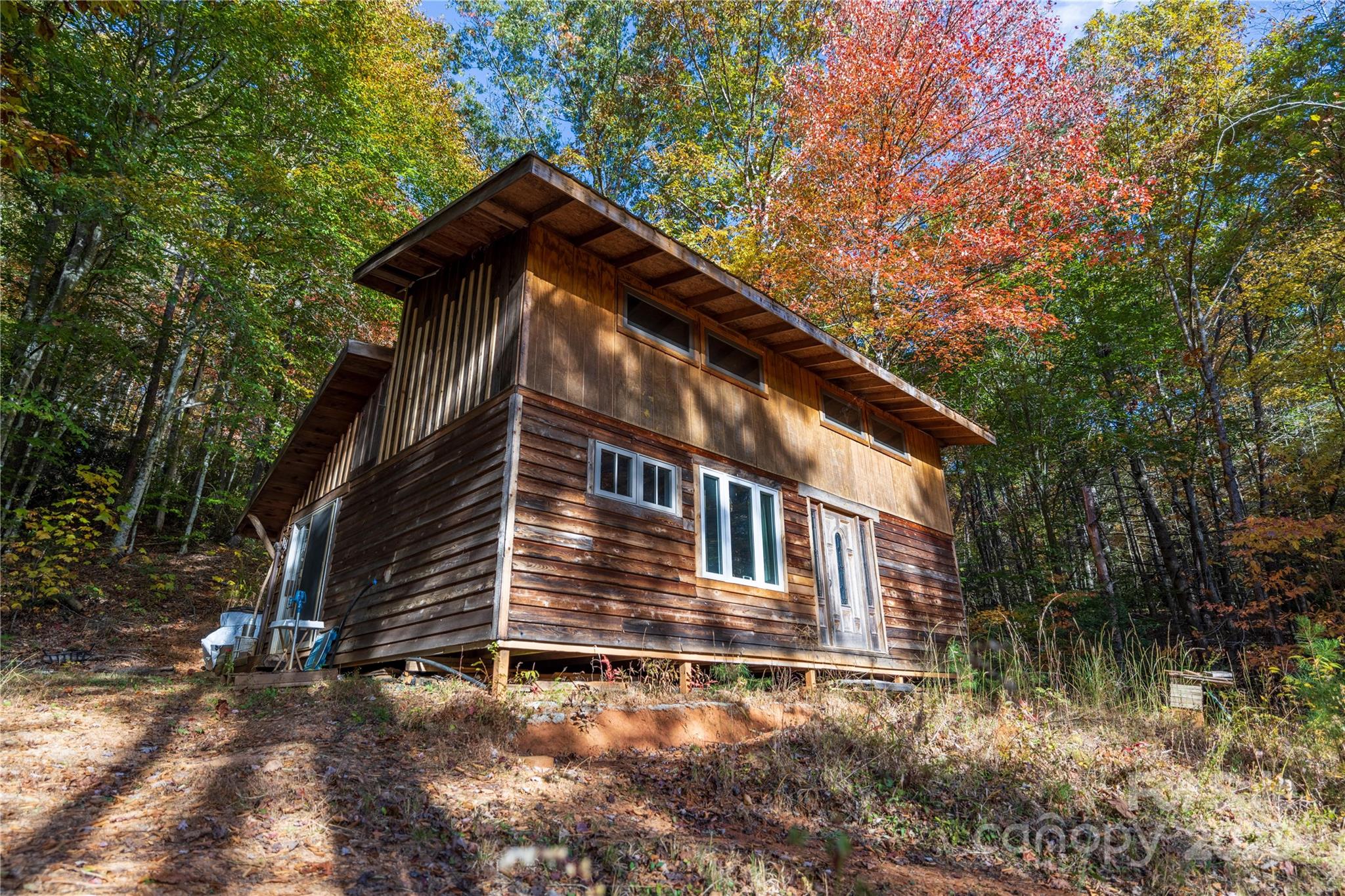 3929 Parker Padgett Road Old Fort, NC 28762 - Photo 17 of 23 a backyard of a house with lots of trees