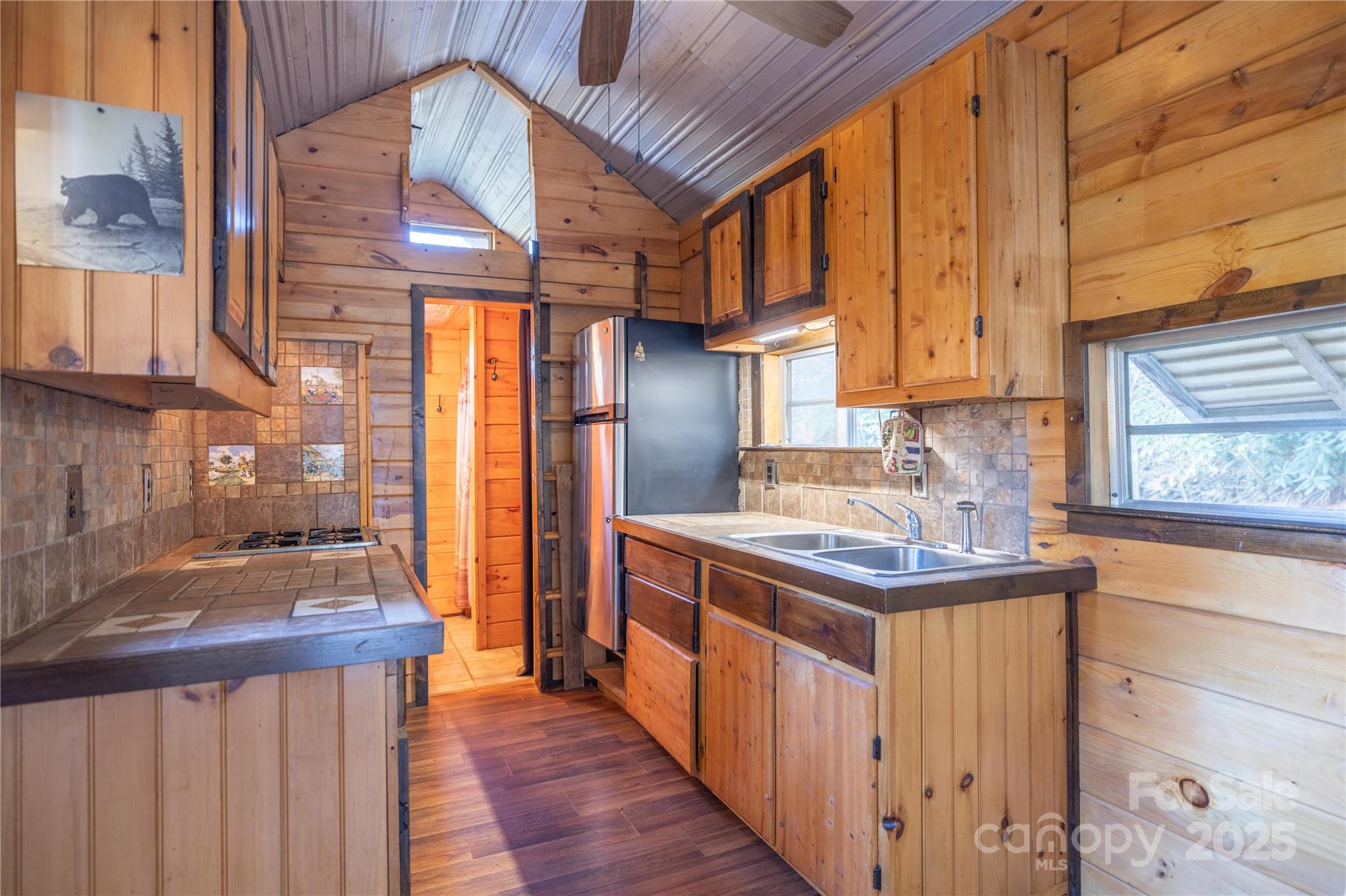 3929 Parker Padgett Road Old Fort, NC 28762 - Photo 4 of 23 a kitchen with stainless steel appliances granite countertop a sink a stove and a wooden floors