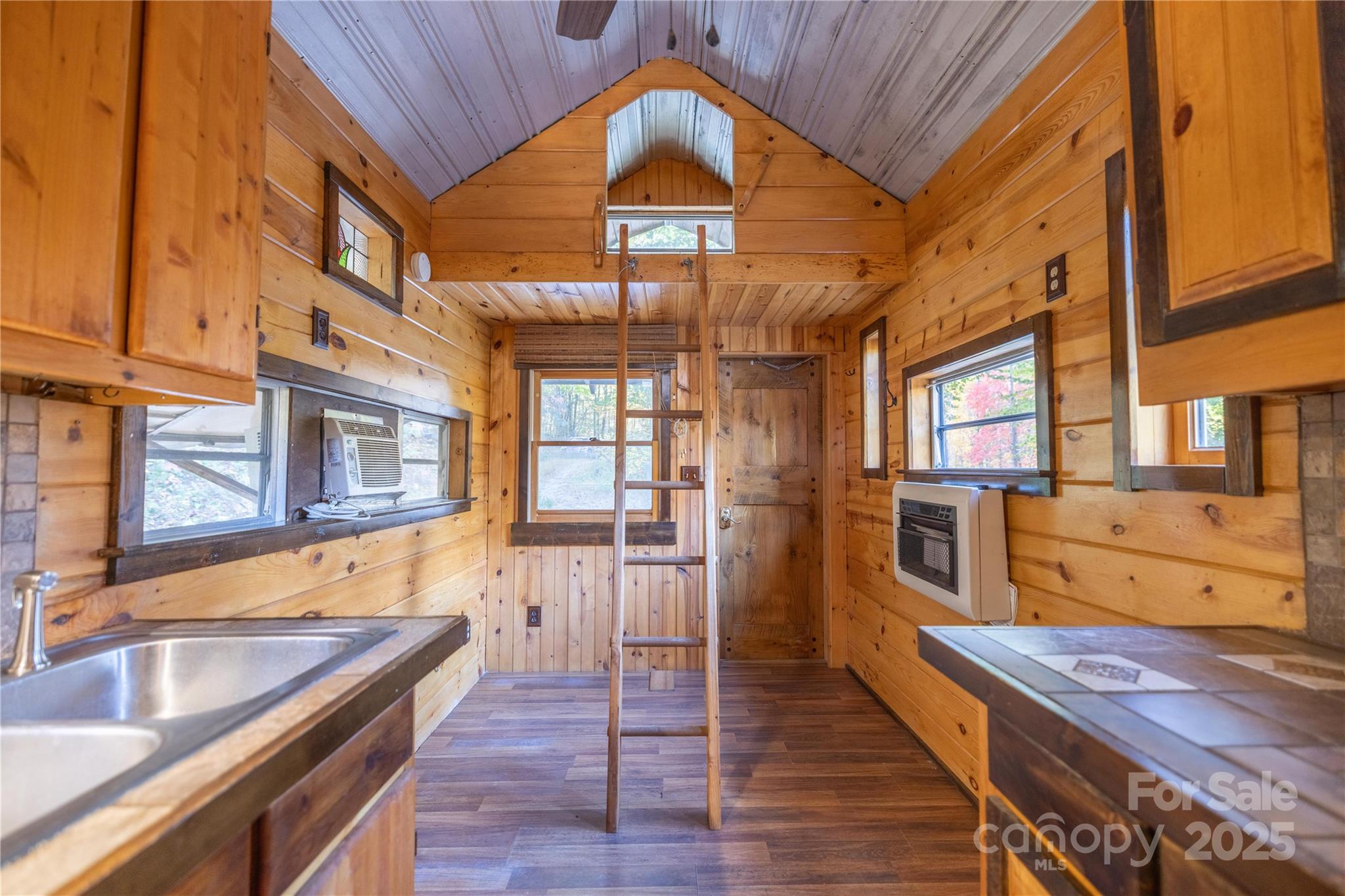 3929 Parker Padgett Road Old Fort, NC 28762 - Photo 8 of 23 a kitchen with stainless steel appliances granite countertop a sink a stove and wooden floors