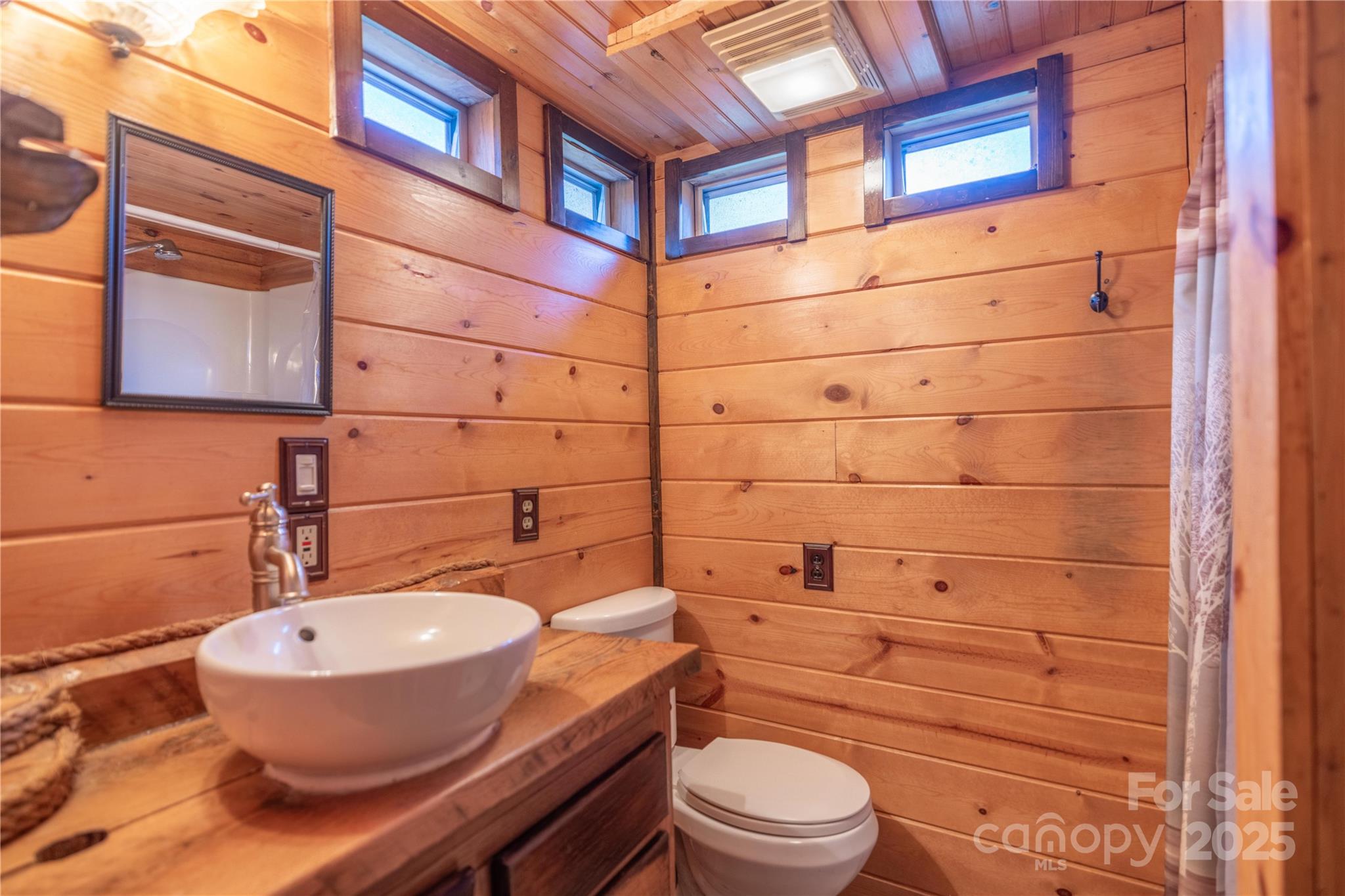 3929 Parker Padgett Road Old Fort, NC 28762 - Photo 9 of 23 a bathroom with a granite countertop toilet sink and mirror
