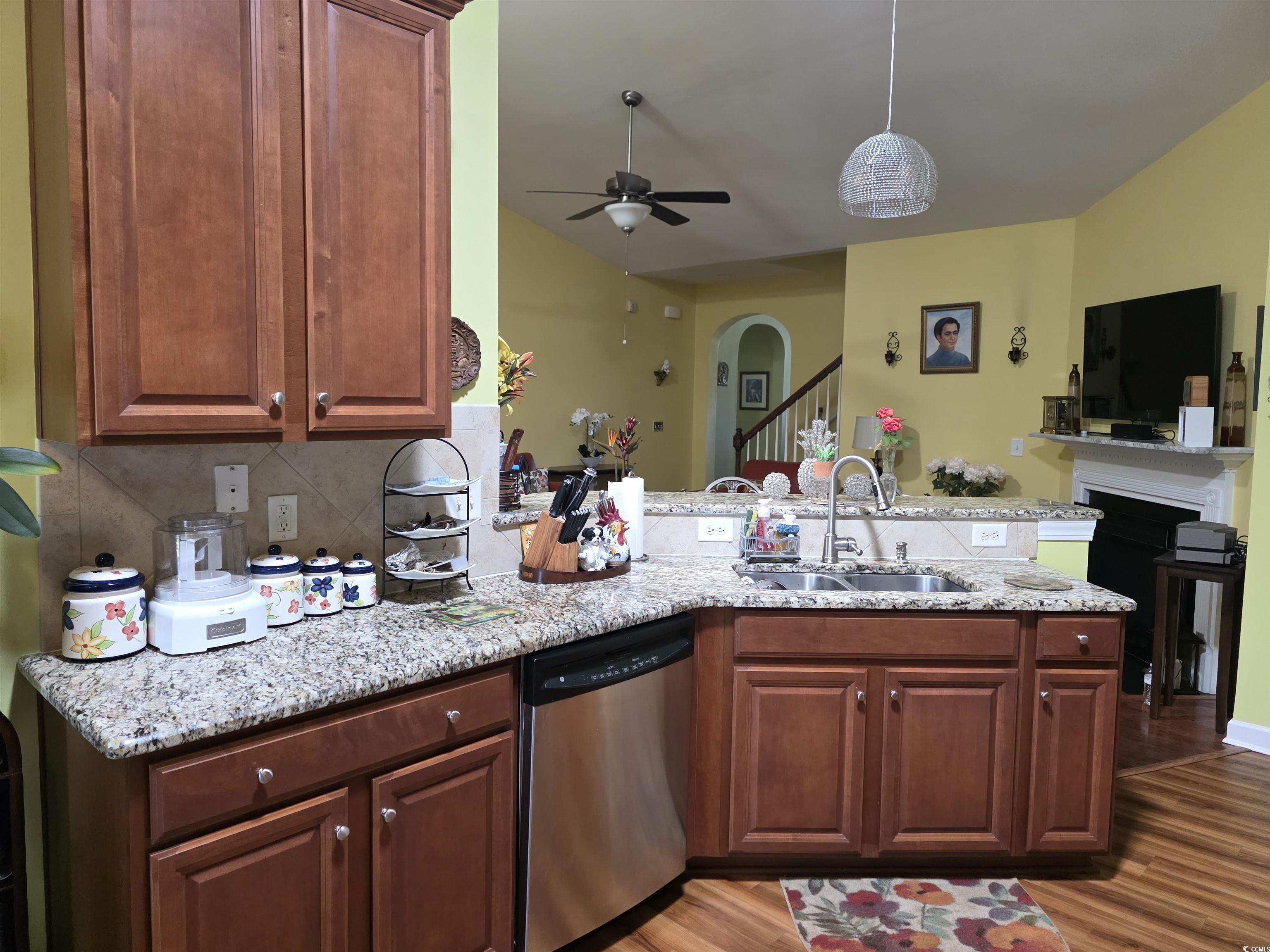 1575 Berkshire Avenue Myrtle Beach, SC 29577 - Photo 30 of 30 Kitchen with a peninsula, dishwasher, open floor plan, a ceiling fan, and light stone countertops