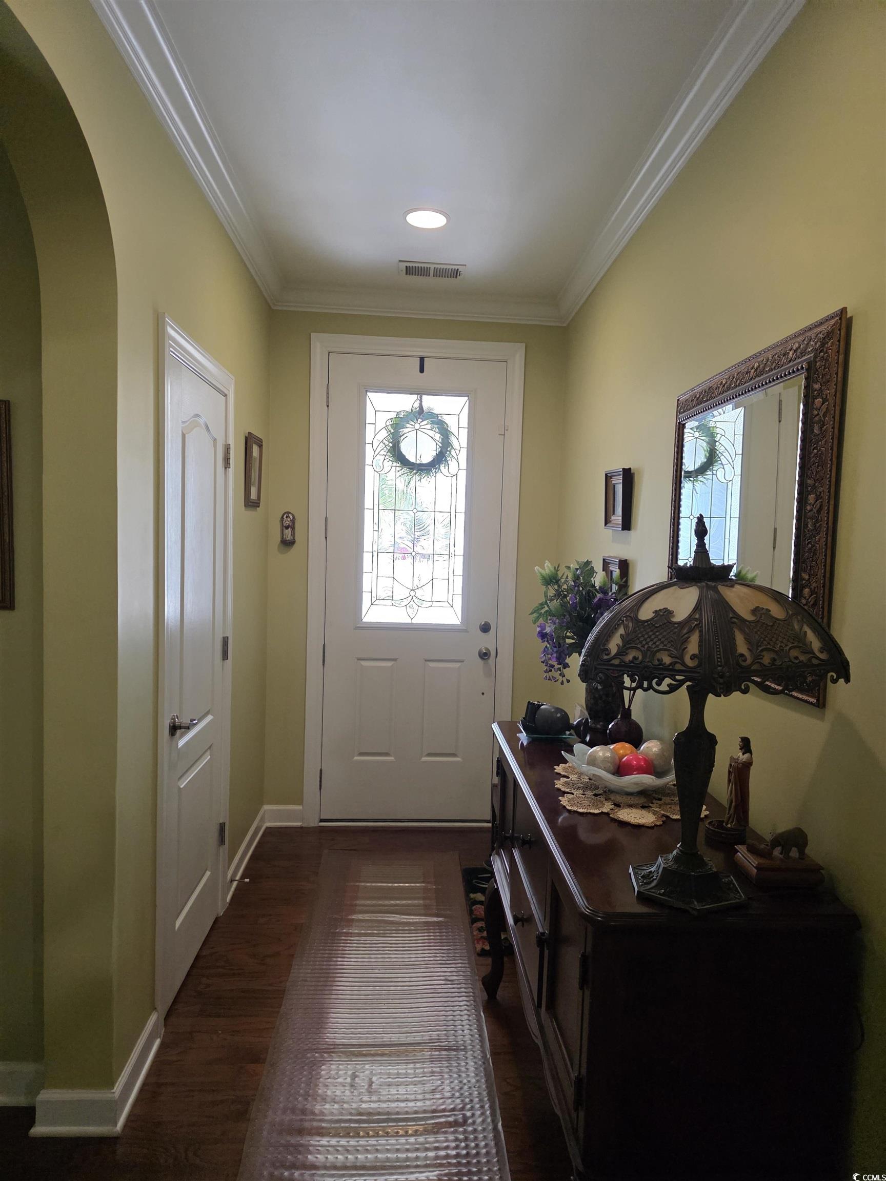 1575 Berkshire Avenue Myrtle Beach, SC 29577 - Photo 10 of 30 Entryway with ornamental molding, arched walkways, and dark wood-type flooring