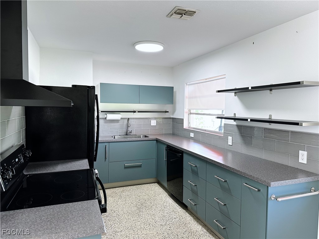 4360 Deleon Street Fort Myers, FL 33901 - Photo 7 of 23 a kitchen with granite countertop a refrigerator and a sink