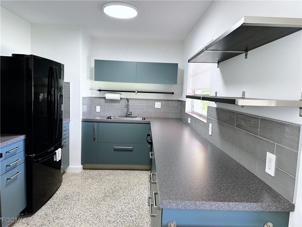 4360 Deleon Street Fort Myers, FL 33901 - Photo 9 of 23 a kitchen with counter top space cabinets and stainless steel appliances