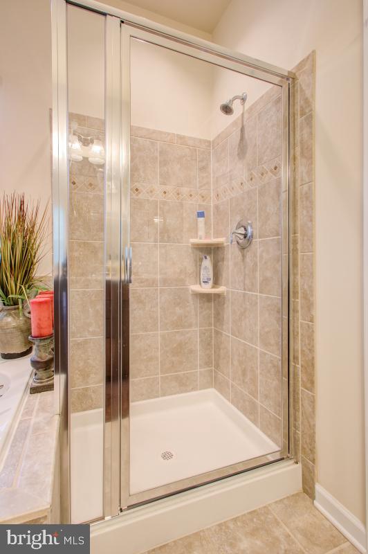 12601 Rustic Rock Lane Beltsville, MD 20705 - Photo 22 of 33 a bathroom with a glass shower door