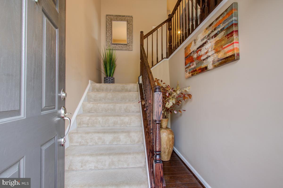 12601 Rustic Rock Lane Beltsville, MD 20705 - Photo 4 of 33 a view of staircase with railing and white walls