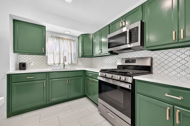 a kitchen with a sink stove and microwave