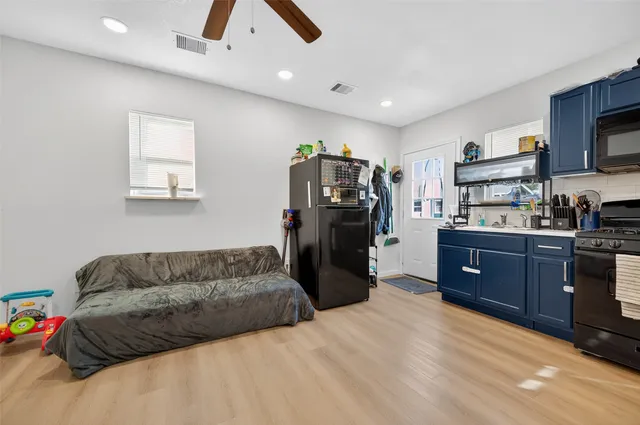 a kitchen with stainless steel appliances granite countertop a sink stove and microwave