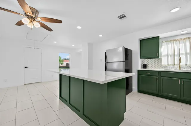 a kitchen with cabinets and window
