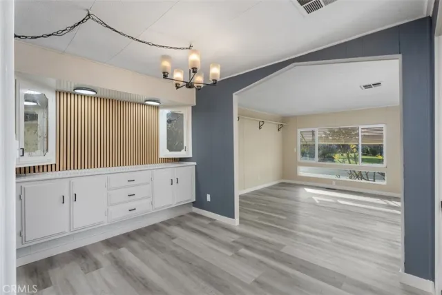 a kitchen with a refrigerator stove and white cabinets