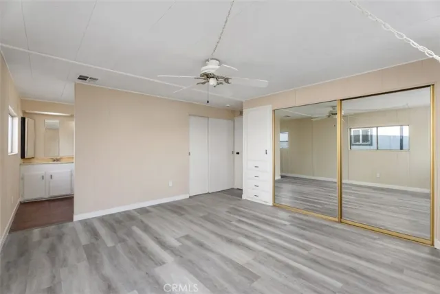 a bathroom with a granite countertop sink mirror and toilet