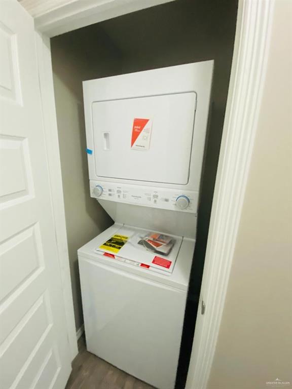 1105 West Kennedy Street, Unit 17 Pharr, TX 78577 - Photo 10 of 11 Laundry room with stacked washer / dryer and dark wood-type flooring