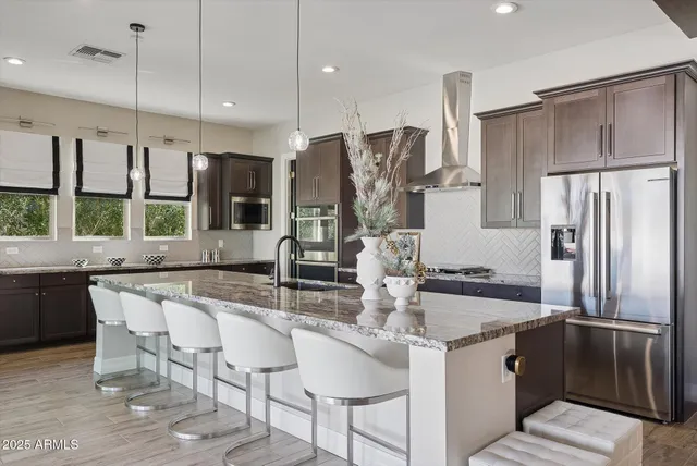 a kitchen with stainless steel appliances granite countertop a sink stove and cabinets