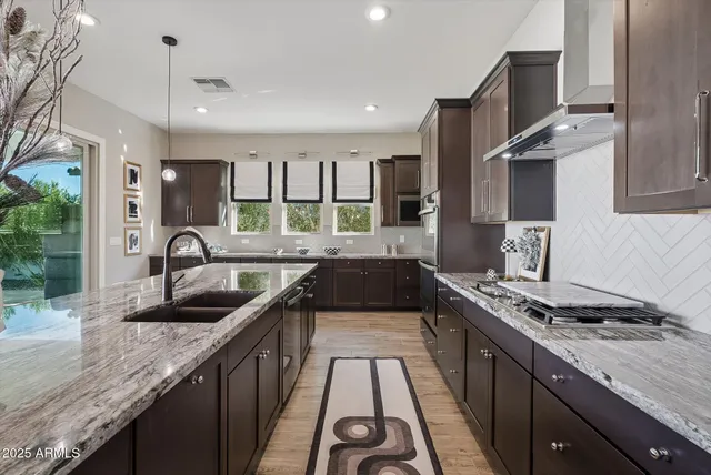 a bathroom with double vanity and a mirror