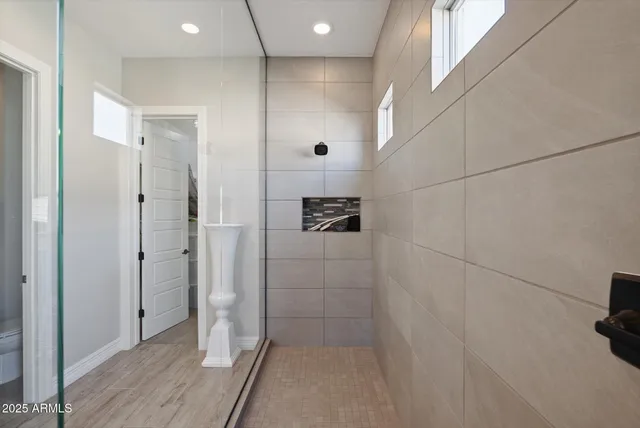 a bathroom with a shower and a sink
