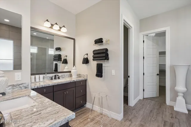 a bedroom with a dresser and a chandelier