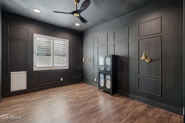 a view of a hallway with wooden shelves and a white door
