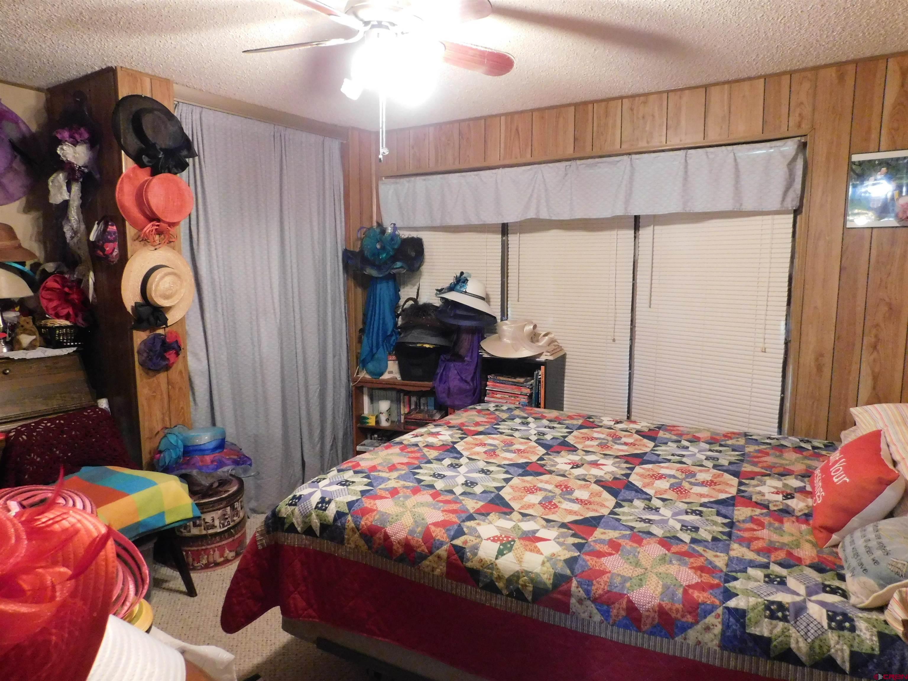 23300 Rd X Lewis, CO 81327 - Photo 13 of 44 a bedroom with a bed and a table in it