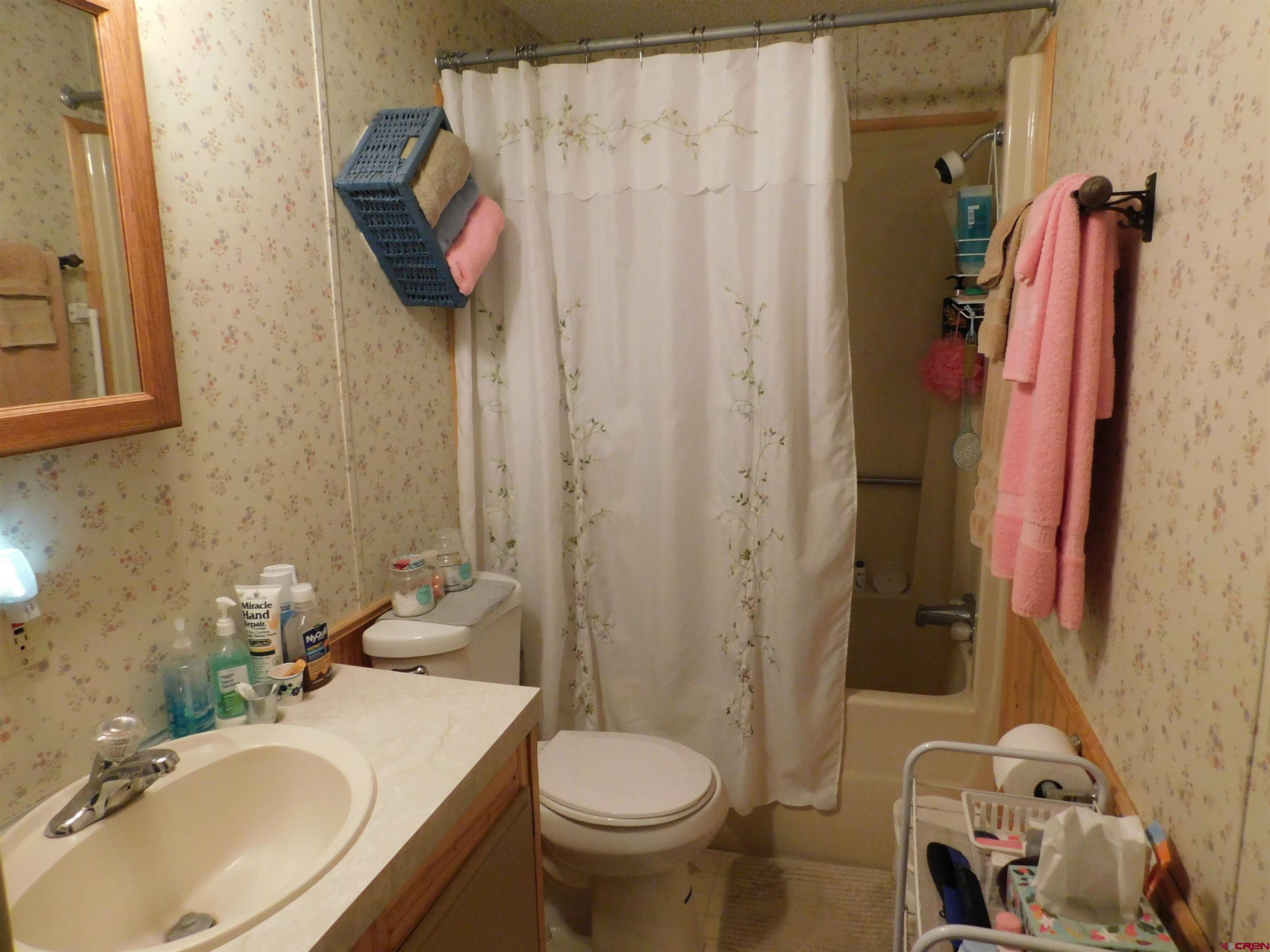 23300 Rd X Lewis, CO 81327 - Photo 14 of 44 a bathroom with a sink toilet and shower