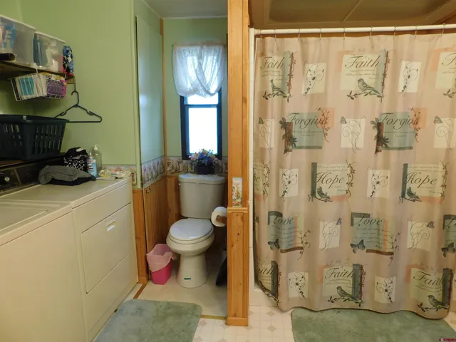 a bathroom with a toilet sink and shower